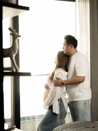A quiet moment of the couple looking out a window, dreaming of the future together.