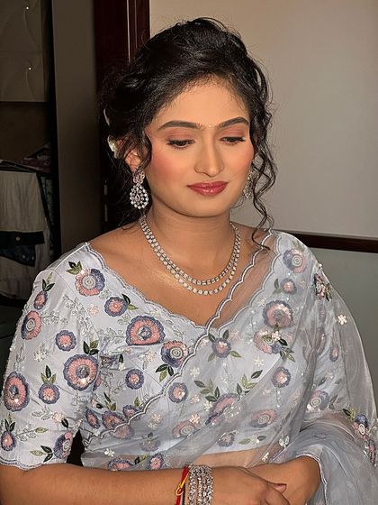 A frontal view of her soft and pretty party makeup. The look is understated yet polished, perfect for a daytime event.