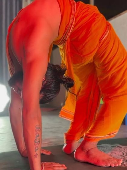 YogGuru Chandra Mohan demonstrates a deep forward fold, showing the level of flexibility that can be achieved through dedicated practice.
