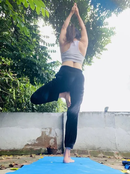 Just breathe. Practicing Vrksasana, or Tree Pose, on my terrace. This pose is all about finding your roots and standing tall.