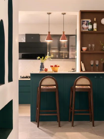 A view into the open kitchen, framed by a custom arched doorway. This perspective shows how the kitchen, dining, and living areas flow into one another, creating a cohesive and inviting space.