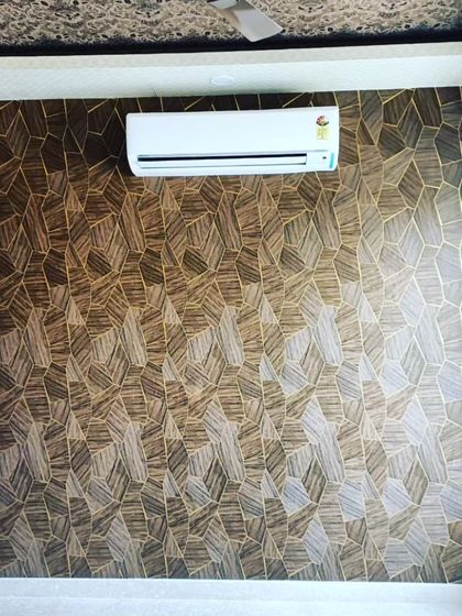An accent wall created with a bold, geometric pattern wallpaper. I can install any type of wallpaper to make a statement in your room, whether it's for a home or an office.