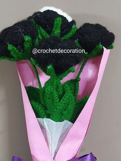 A bold and dramatic bouquet of black and white crochet roses, wrapped in pink paper with a purple ribbon. This is a great option for someone who loves a gothic or unconventional aesthetic.