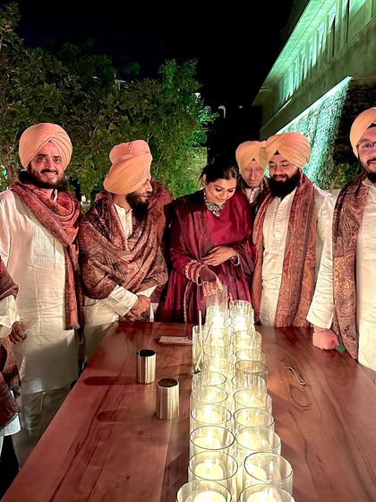 Another group shot of the band, gathered around a beautifully lit table after a show.