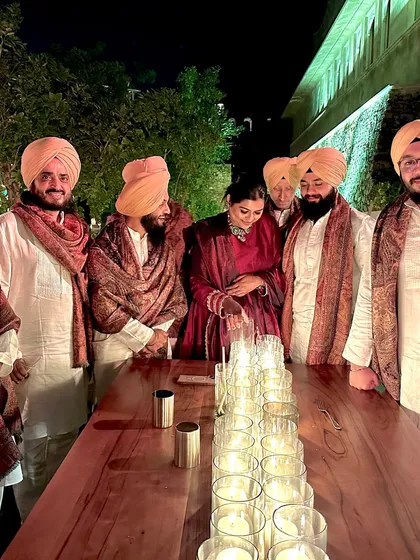 Another group shot of the band, gathered around a beautifully lit table after a show.