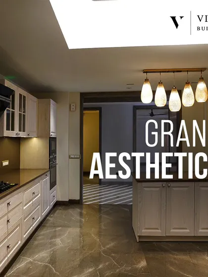 Grand aesthetics are on display in this spacious kitchen. The light wood cabinets and island provide a beautiful contrast to the dark marble flooring, creating a bright and inviting space.
