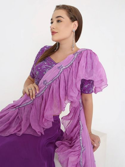 It's all in the details. A closer look at this lavender beauty reveals a hand-embroidered blouse and a soft, layered ruffle dupatta for a graceful flow. Perfect for an evening of elegance.