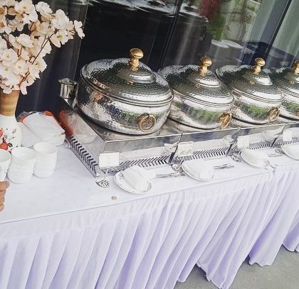 The full buffet line for the Sudha Carpets lunch. The setup is clean, professional, and inviting for the 50 guests.