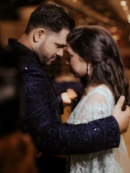 A moment of quiet connection during their engagement. Foreheads together, they are in their own world, a promise of unity and understanding.