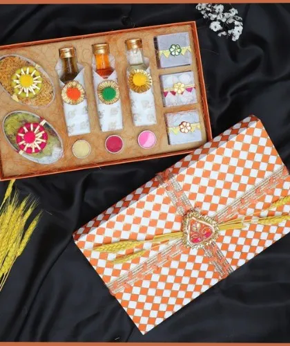 Our checkered Holi hamper is a complete celebration in a box. It includes bottles of Thandai syrup, herbal gulal, and sweet boxes, all beautifully arranged and ready to gift.