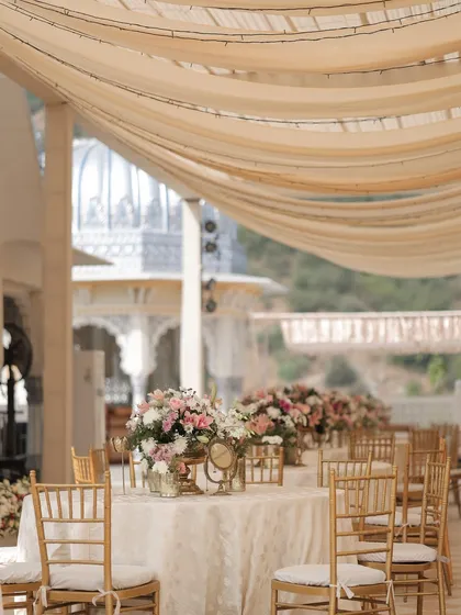 A closer look at the dining tables, showing the beautiful texture of the linens and the soft pastel floral arrangements.