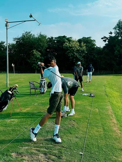 A young golfer shows perfect form in his follow-through. We love seeing the next generation fall in love with the game.