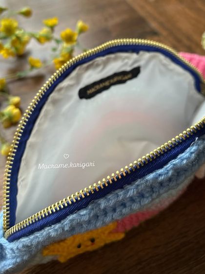 A peek inside the kids' rainbow bag, which is fully lined to hold small treasures securely. The quality zipper ensures everything stays safe.