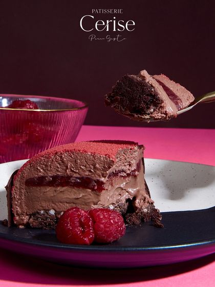 A slice of the Choco Framboise, a dessert made with fresh raspberries and luscious dark chocolate.