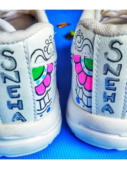 The back of the sneakers, personalized with the name 'Sneha' in a custom font, demonstrating how I can add a personal touch to your wearable art.