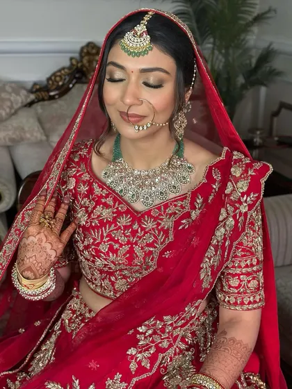 The bride with her dupatta set, ready for her ceremony. The soft glam makeup holds its own against the bold red of her lehenga, creating a balanced and beautiful look.