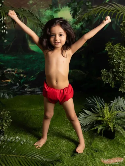 A triumphant pose in the heart of the jungle. These themed shoots are all about capturing your child's powerful imagination and playful spirit.