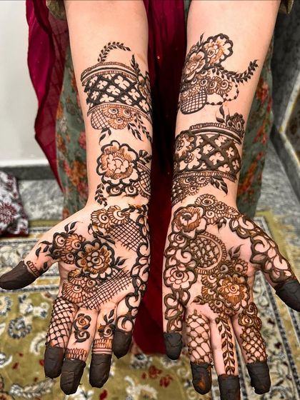 This floral and geometric design is perfect for a bride or her close family. The patterns are dense on the palm and fingers, with elegant bands wrapping around the wrist.