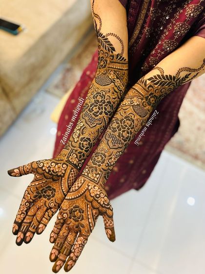A full view of a stunning Pakistani bridal design with bold, dark Arabic floral elements.