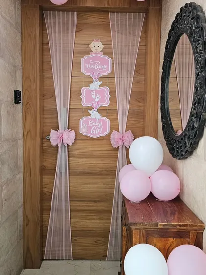 Another view of the baby girl welcome door decor, showing how it fits into a home's entryway.