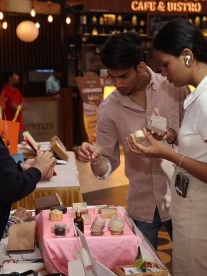 A young couple exploring the different scents and textures of my products. In-person events allow you to experience the quality firsthand.