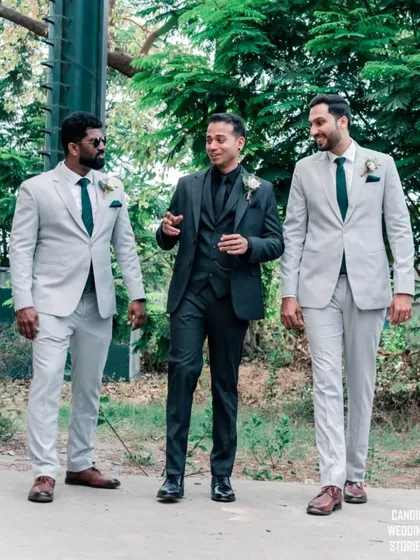 The groom walking and chatting with his groomsmen, a candid moment capturing their relaxed friendship and excitement.