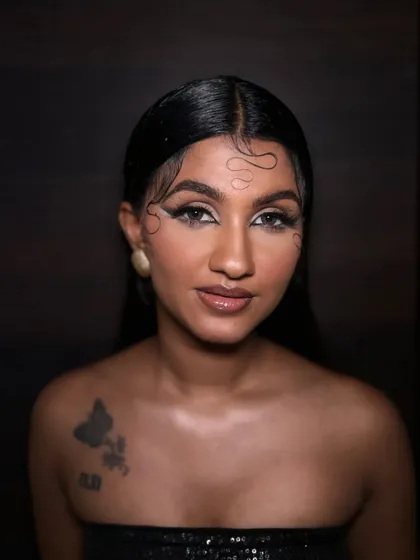 A direct, front-facing shot that showcases the symmetry of the graphic eyeliner and the overall polished feel of this high-fashion makeup look.