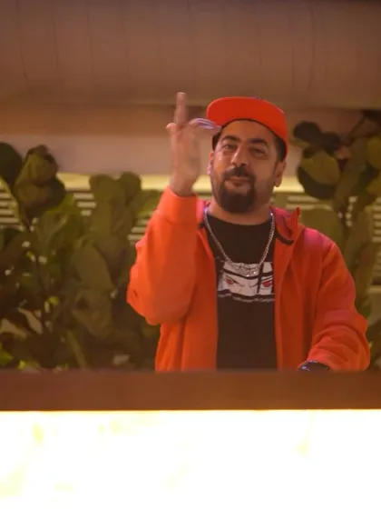 Hyping up the crowd from the DJ booth at Pangeo.