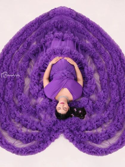 Our signature overhead "sleeping pose" in a magnificent purple ruffled gown arranged to form a heart. This is a truly unique and artistic studio shot.