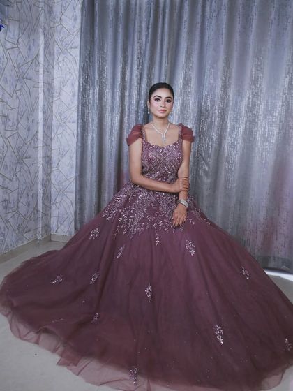 A seated portrait showing the grand sweep of the gown's skirt, making it look like a royal dress.