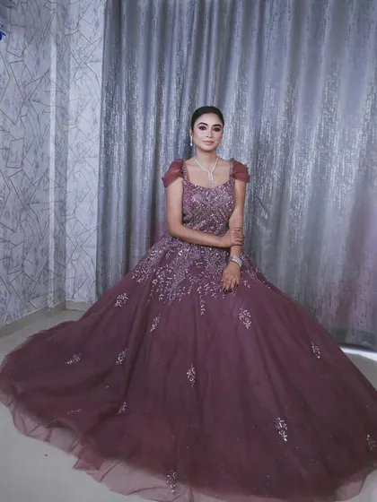 This mauve-purple ball gown is pure royalty. The full, sweeping skirt and intricately beaded bodice are perfect for a grand reception.