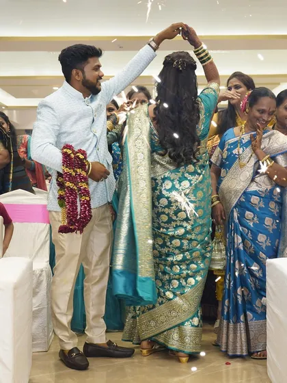 A fun, candid moment on the dance floor. The bride's hairstyle, a cascade of curls, looks beautiful as she twirls with her partner.