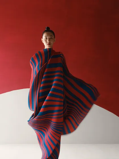 For the same Payal Khandwala campaign, we used bold color blocking. The sculptural, pleated textile in red and blue creates a powerful silhouette against the minimalist set.