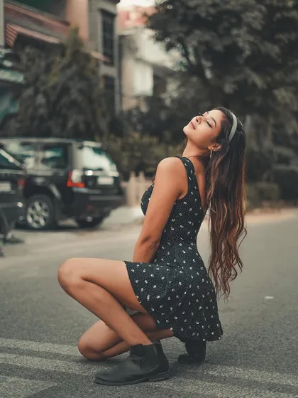 Soaking in the sun. This shot uses the natural light and the simple street setting to create a warm, carefree portrait.