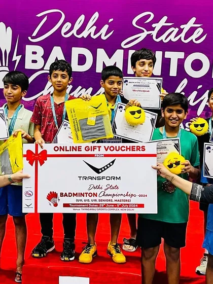 A group of our smiling champions holding their certificates and prizes at the Delhi State Badminton Championships. This image captures the joy and reward of their hard work.