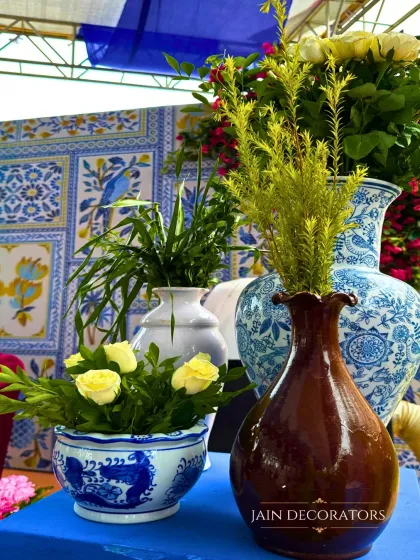 A close-up of the beautiful blue and white pottery used as vases. These details, set against a matching tiled backdrop, help to create a cohesive and stylish theme.