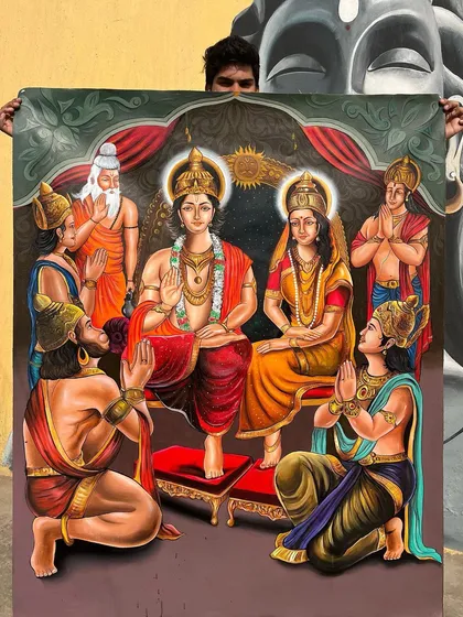 Holding up my completed Ram Darbar painting. This large acrylic on canvas piece is one of my most detailed works, showing the full divine family.