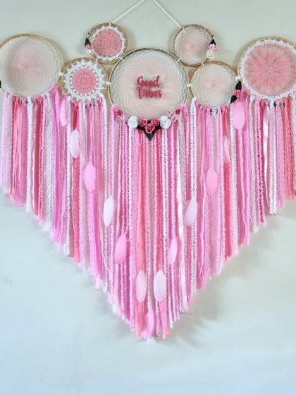 Embrace the delicate beauty of this 4-foot Pink Floral Cluster Dreamcatcher. It's a perfect statement piece for a living room, nursery, or even as a wedding backdrop.