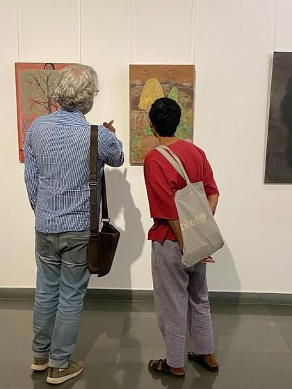Two visitors discussing the artworks on display.