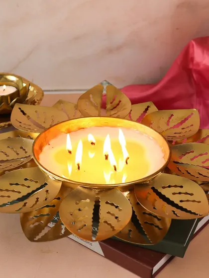 Our grand Lotus Urli candle, lit and casting a warm glow. This is the centerpiece of our festive moodboard, perfect for the upcoming season.