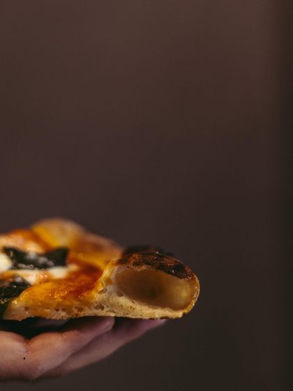 Just a peekaboo. The crust matters, and this close-up shows the beautiful, airy structure that makes our Neapolitan pizzas so special.
