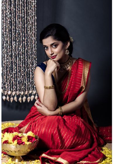 A lovely seated portrait of the model with a bowl of flowers. This image captures the essence of Indian festivals like Makar Sankranti, blending tradition with beauty.