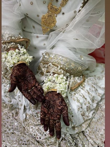 A beautiful shot of the bride in her white nikah outfit, with her dark henna providing a stunning contrast.