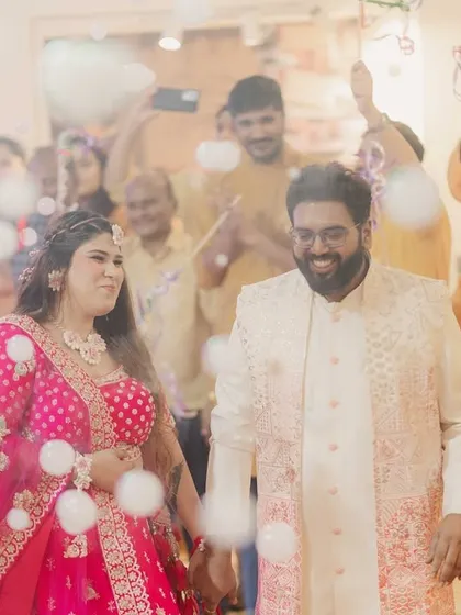 A joyful couple's entry surrounded by friends and bubbles. We plan these moments to be full of life and happiness.