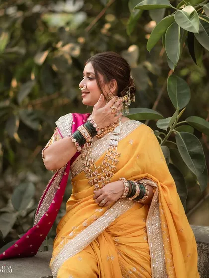 A candid moment showing the bride's elegant posture and the beautiful details of her hair and jewelry. The makeup is subtle, allowing her natural grace to be the focus.