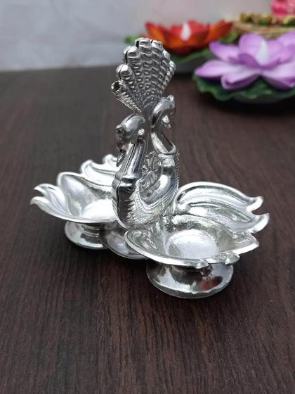 This Kamal Hamsa kumkum daani features two lotus-shaped bowls held by sacred Hamsa birds. It's a beautiful way to present haldi and kumkum.