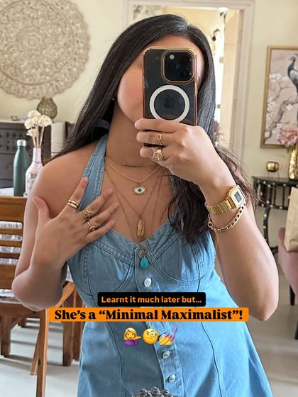 I call my style 'Minimal Maximalist'. Here, I've layered multiple delicate gold necklaces over a simple denim halter dress to create a look that's both understated and detailed.