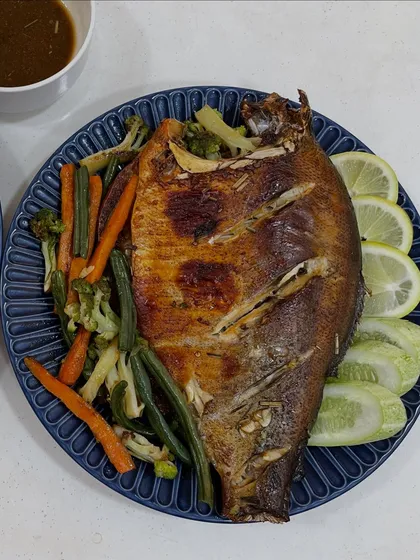 We also prepare fresh seafood in the traditional Naga style. Here is a whole roasted fish, marinated in our house spices and served with steamed seasonal vegetables, fresh lemon, and a side of savory dipping sauce.