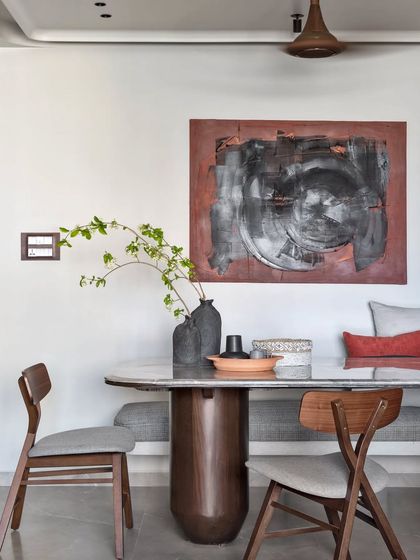 I call this visual poetry. The abstract artwork, custom bench seating, and sculptural dining table create a scene that is impactful yet calming, perfect for shared meals.