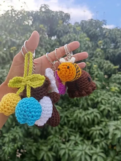 A collection of custom keychains made for a client, including tulips, a bee, and a bear, showing the variety of a mixed bulk order.